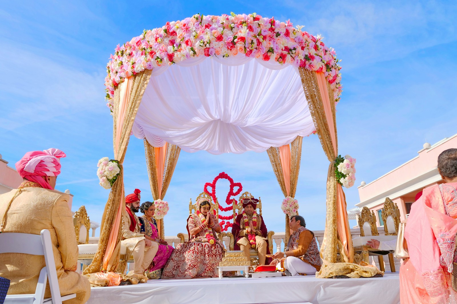 Hindu wedding mandap ceremony with bride, groom and priest