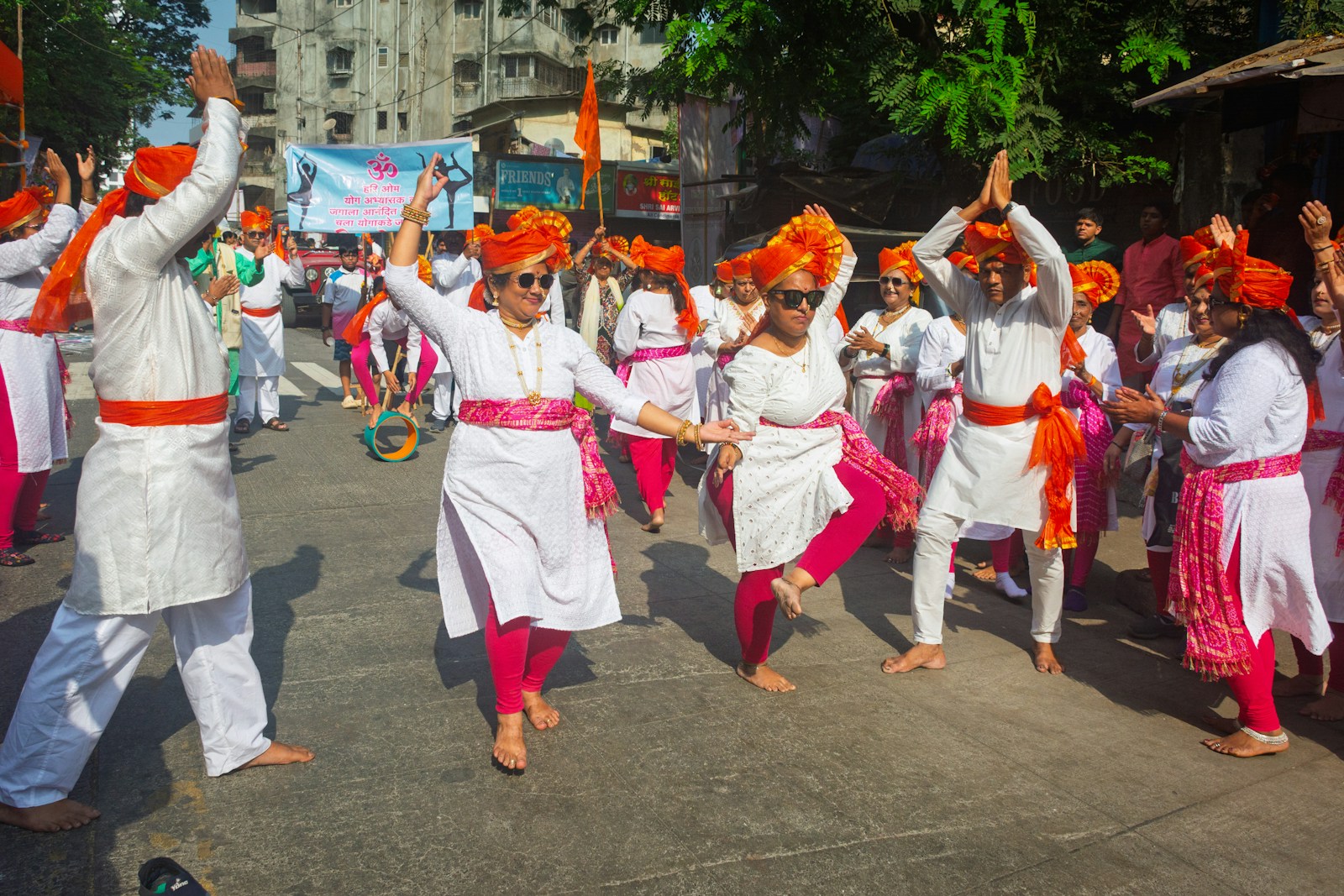 Indian wedding baraat — guests dancing in traditional attire on the street